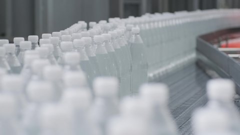 Conveyor belt with bottles of drinking water at a modern beverage plant Arkistovideo