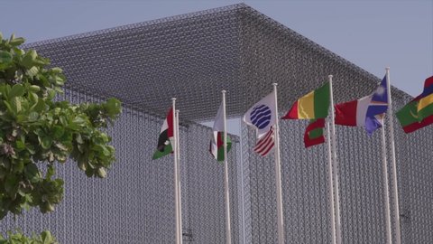 Dubai, United Arab Emirates - October 2021: Flags of the world blowing in the wind at the entrance of Expo 2020
