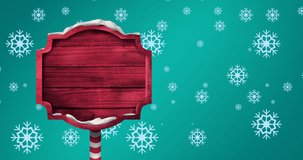 Animation of falling snowflakes over blank wooden sign with copy space. christmas, tradition and celebration concept digitally generated video.