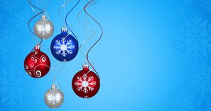 Animation of christmas balls over snowflakes on blue background. christmas, tradition and celebration concept digitally generated video.