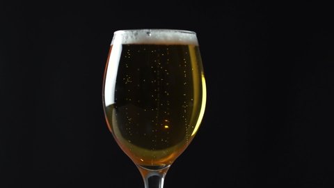 beer in glass on black background footage