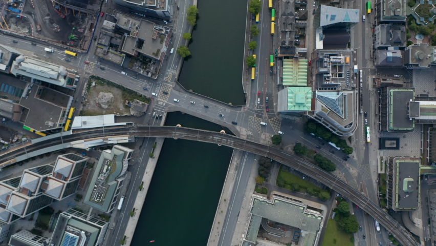 Aerial birds eye overhead top down view of traffic on bridge across Liffey river. Railway bridge next by. Dublin, Ireland