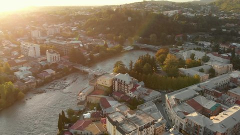 Aerial view of Kutaisi cityscape at sunset in Georgia. Drone footage of the Kutaisi city center, white bridge over the Rioni river.