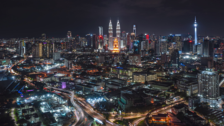 Malaysia Time lapse: Aerial city during night overlooking Kuala Lumpur city skyline and the Kuala Lumpur General Hospital with busy roundabout and streets. Tilt up motion timelapse. Prores 4K | Shutterstock HD Video #1080850925