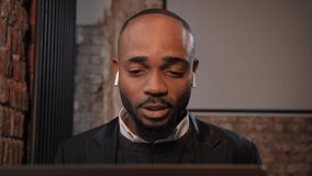 a black man works at a laptop close-up of his face. video conferences