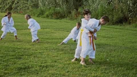 Kids sparring during outdoor group karate training. High quality 4k footage