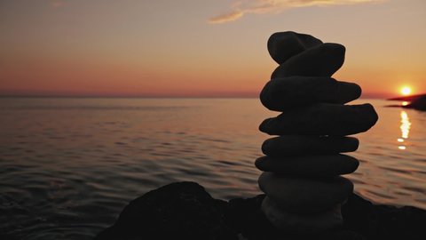 Zen stones on a ocean sea cliff in sunset sunrise time.