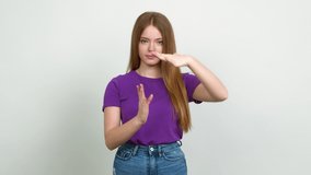 Teenager girl doing time out gesture over isolated background