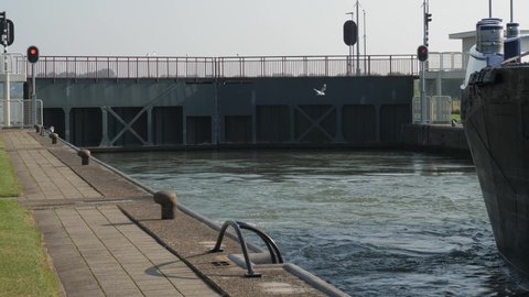 Weir and locks in Amerongen the Netherlands, seagulls flying before sluice door