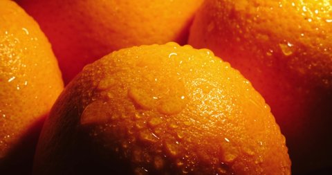Ripe orange. orange in drops of water. Orange in a beam of light. Ripe oranges in water droplets in a beam of light. Ripe orange peel