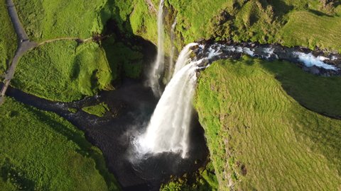 Mountain Waterfall Around Famous Waterfall In Iceland Water Flowing Through High Cliffs During Summer with Panoramic Drone Shot