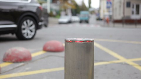 Retractable automatic bollard with LEDs near the pedestrian zone.
