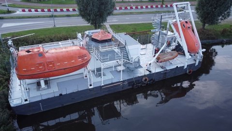 GRONINGEN, NETHERLANDS - 26. SEPTEMBER 2021: Lifeboat training  ground for jack-up offshore rig leviathan lifeboat close up.
