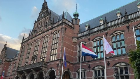 GRONINGEN, NETHERLANDS - 15. OCTOBER 2021: Historical Building of the University of Groningen, Flags waving in the Wind