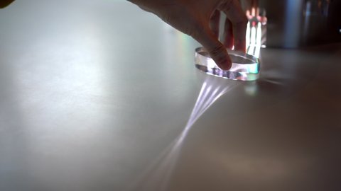 Hand spinning oval clear prism to distort light 