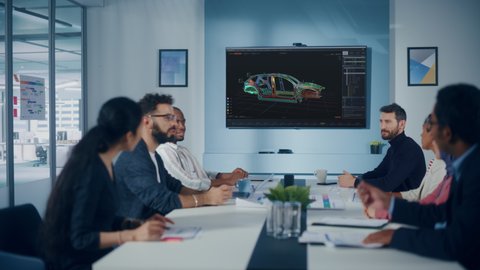 Multi-Ethnic Office Conference Room Meeting: Team of Industrial Engineers, Technicians Talk, Use Digital Interactive TV with 3D Car Concept. Eco-friendly, Green Renewable Energy Vehicle Prototype