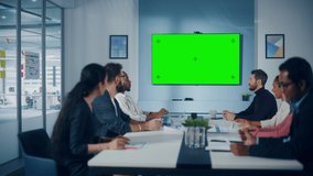 Multi-Ethnic Office Conference Room Meeting: Diverse Team of Successful Managers, Executives Talk, Use Green Screen Chroma Key TV. Group of Businesspeople Work on Strategy for an e-Commerce Startup - Powered by Shutterstock - Get 15% off with code: PIKWIZARD15