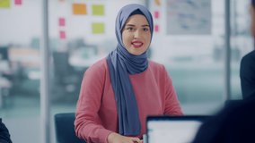 Diverse Modern Office: Portrait of Successful Young Muslim Businesswoman Wearing Hijab Leads Meeting, talks about Company Growth. Creative Digital Entrepreneurs Work on e-Commerce Project. Slow Motion - Powered by Shutterstock - Get 15% off with code: PIKWIZARD15