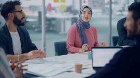 Diverse Modern Office: Successful Young Muslim Businesswoman Wearing Hijab Leads Meeting Discussion with Managers, Talks about Company Growth. Creative Digital Entrepreneurs Work on e-Commerce Project - Powered by Shutterstock - Get 15% off with code: PIKWIZARD15