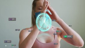 Animation of clock over social media icons and woman meditating in face mask. global connections during covid 19 pandemic, digital interface concept digitally generated video. - Powered by Shutterstock - Get 15% off with code: PIKWIZARD15