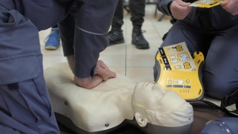 First aid cardiopulmonary resuscitation training demonstration, closeup, handheld