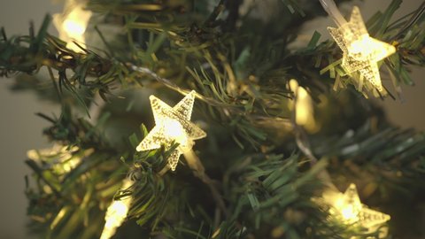 Turning the star-shaped lights on the Christmas tree on