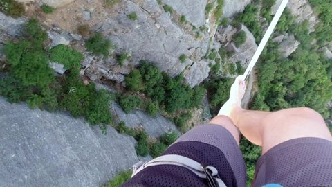 Concept of balance: The precipice at the base of the Bismantova stone seen from a tightrope walker on the slackline 200 meters above, Castelnovo nè Monti, Reggio Emilia, Italy