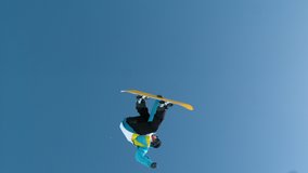 TIME WARP, SLOW MOTION: Athletic male snowboarder does an awesome spinning grab trick during a fun winter vacation in the Slovenian mountains. Cinematic shot of a spectacular snowboarding trick. - Powered by Shutterstock - Get 15% off with code: PIKWIZARD15