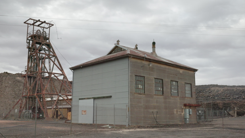 pan of a headframe and derelict building at a historic mine in broken hill of western nsw, australia