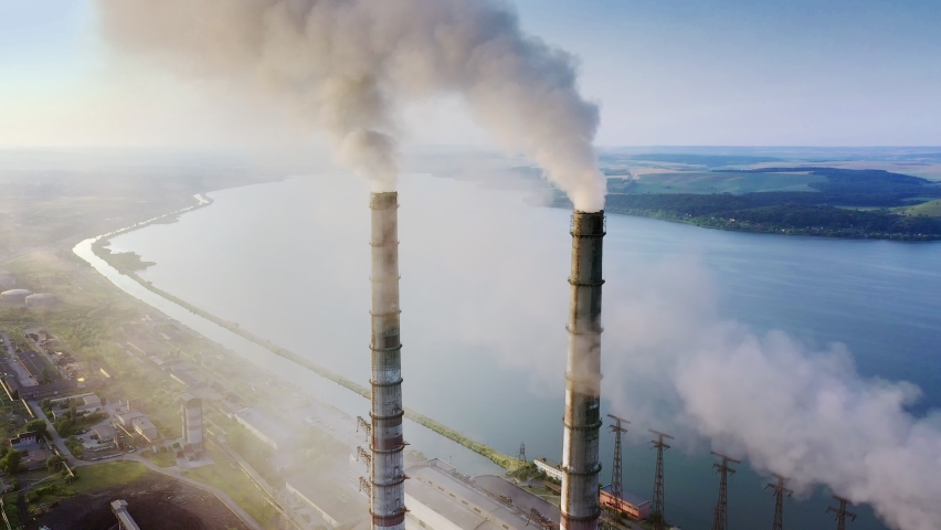 Aerial view of coal power plant high pipes with black smokestack polluting atmosphere. Electricity production with fossil fuel concept | Shutterstock HD Video #1080897950