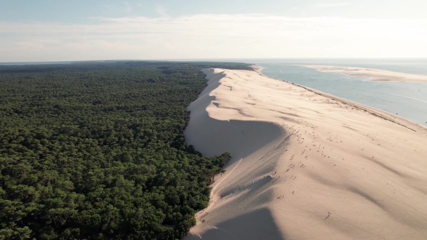 Color contrast between green vegetation and white dunes of Pilat at Arcachon, France. Aerial forward Royalty-Free Stock Footage #1080902882