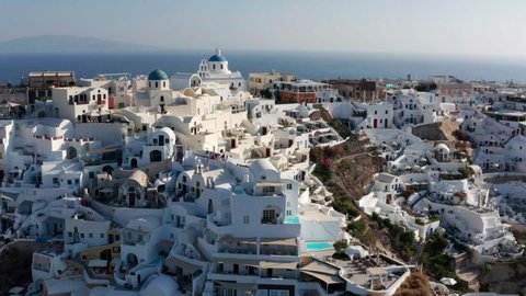Scenic View Over The Famous Village Of Oia At The Island Santorini, Greece - aerial drone shot