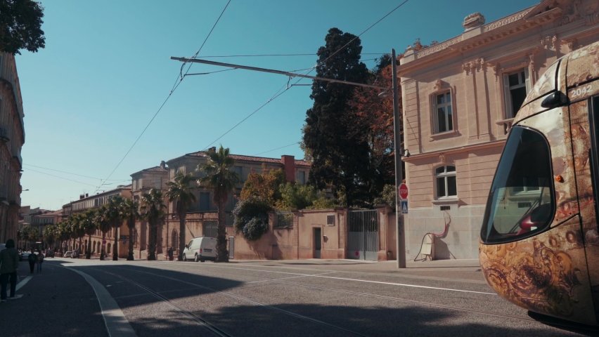 A yellow tram is heading towards the city, Montpellier - France