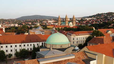 Mosque Of Pasha Qasim In Pecs, Hungary With Pecs Cathedral In Distance. aerial orbit