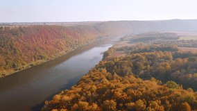 Shooting of the attractive grand river from a bird's eye view. Camera moves forward. Location place Dniester canyon, Ukraine, Europe. Cinematic aerial shot. Beauty of earth. Filmed 4k, drone video.
