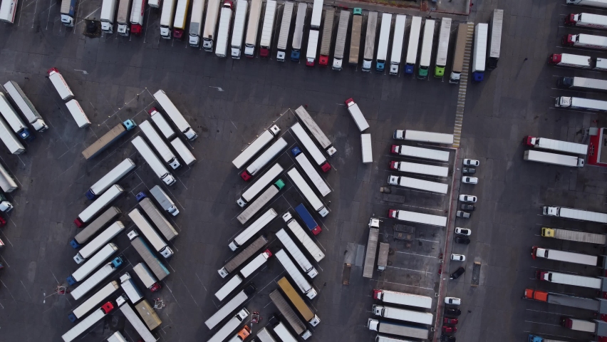 Lots of trucks parked in a long row aerial top view. 4K drone video. Royalty-Free Stock Footage #1080915902