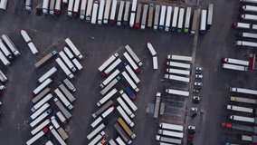 Lots of trucks parked in a long row aerial top view. 4K drone video.