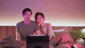 asian adult lover marry couple enjoy sing and happiness dance move hand wave together watch concert online from laptop or tablet on bed at home,Close up of people enjoying musical concert on laptop.  - Powered by Shutterstock - Get 15% off with code: PIKWIZARD15