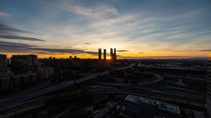 Madrid Skyline and motorway traffic Timelapse day to night sunset 