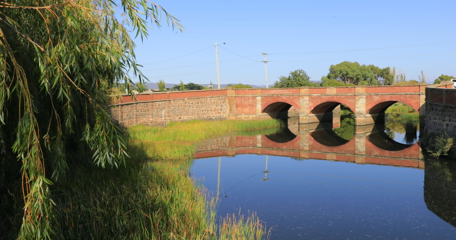 Left to right panning motion of the Red Bridge crosses the Elizabeth River at Campbell Town, Built in 1838 using penal labour, it is the oldest surviving brick arch bridge in Australia