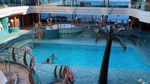 Bahamas - October 11, 2021: A view of people swimming in the Solarium pool aboard the MSC Cruise Ship Divina.
