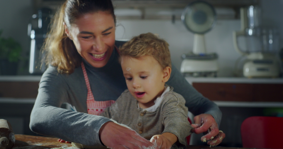 Portrait of Mother and Son in the Kitchen Baking Together. Playful Little Toddler and his Mom Playing with Dough and Flour. Family Bonding Moment full of Motherly Love. Happy Childhood Memories Royalty-Free Stock Footage #1080927332