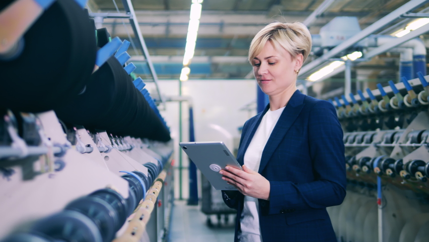 Female inspector is supervising a sewing machinery complex Royalty-Free Stock Footage #1080929657