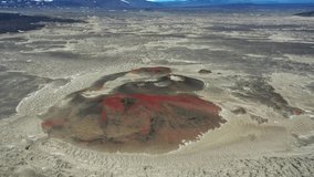 4k aerial view of some red colour extinct volcanoes in the highlands of Iceland.