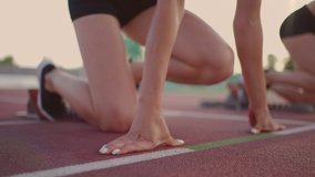 Close-up three female track and water athletes on the start line at the stadium competition prepare and run away in a sprint race. - Powered by Shutterstock - Get 15% off with code: PIKWIZARD15