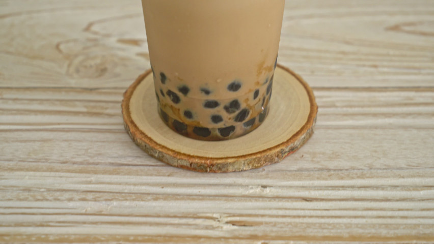 Taiwan milk tea with bubble and cheese burned on wood table
