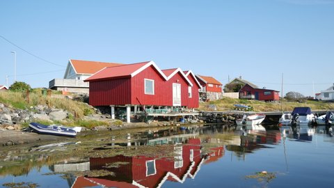 Fishing boats and nets on coast, houses on background, Roro Island in Gothenburg archipelago, Sweden