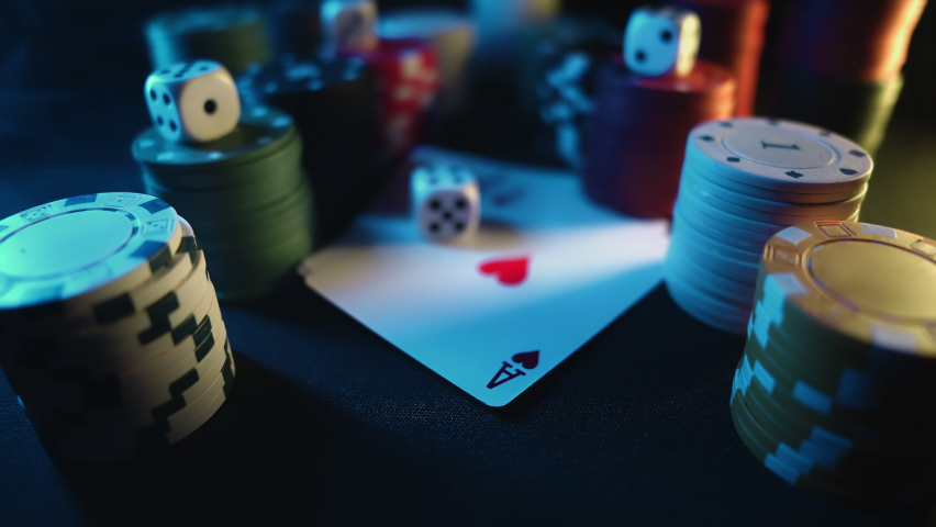 Casino chips with dice and playing cards on a dark table. Concept of gambling or poker and entertainment. Close up macro shoot. Online casino betting Royalty-Free Stock Footage #1080947750