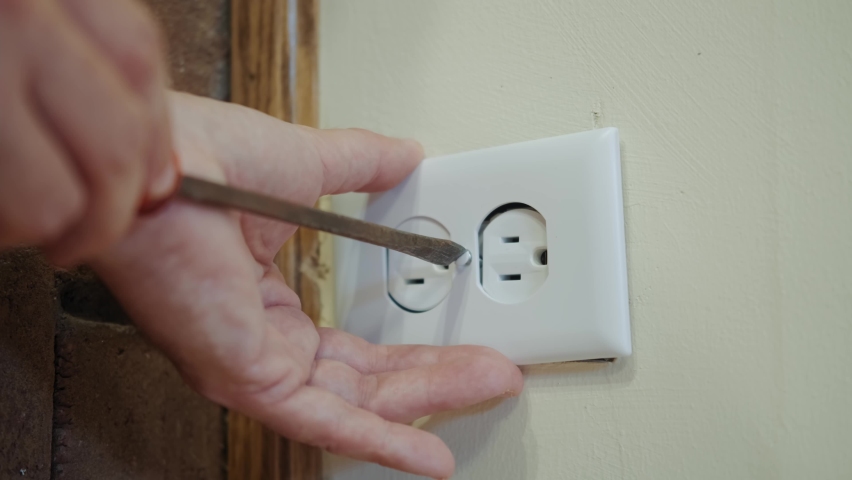 Close up view. Worker electrician repair an electrical outlet in apartment. | Shutterstock HD Video #1080949310