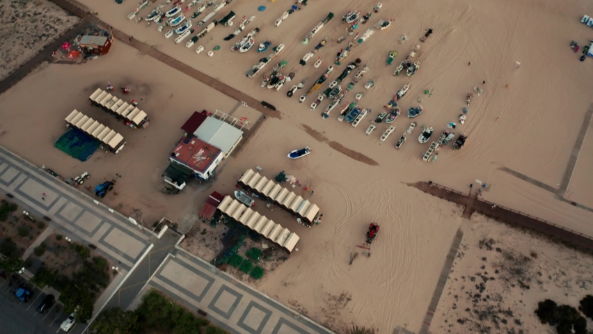 Boats on a beach at sunset